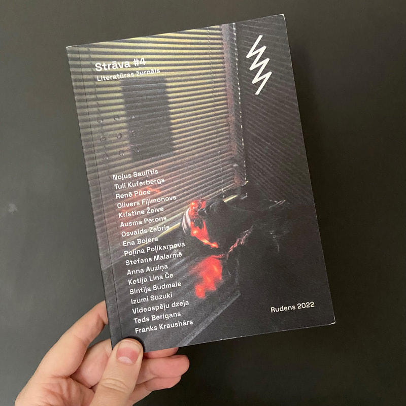 A hand holds up a copy of the latest edition of Latvian literary magazine Strāva. The cover consists of the name of the magazine, the date of publication and a list of contributors printed over a photograph of a window with blinds.